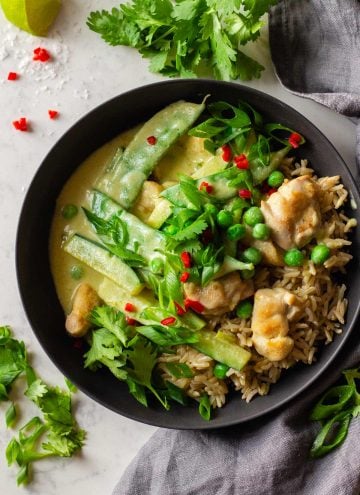 Chicken Thai Green Curry served over brown rice in a grey bowl.