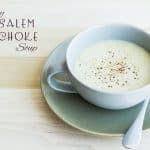 Creamy Jerusalem Artichoke Soup in a green bowl on a plate with a spoon with text overlay.