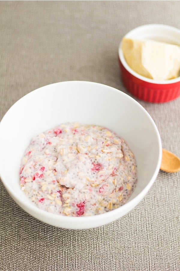 Ingredients for Raspberry White Chocolate Overnight Oats mixed in a white bowl.