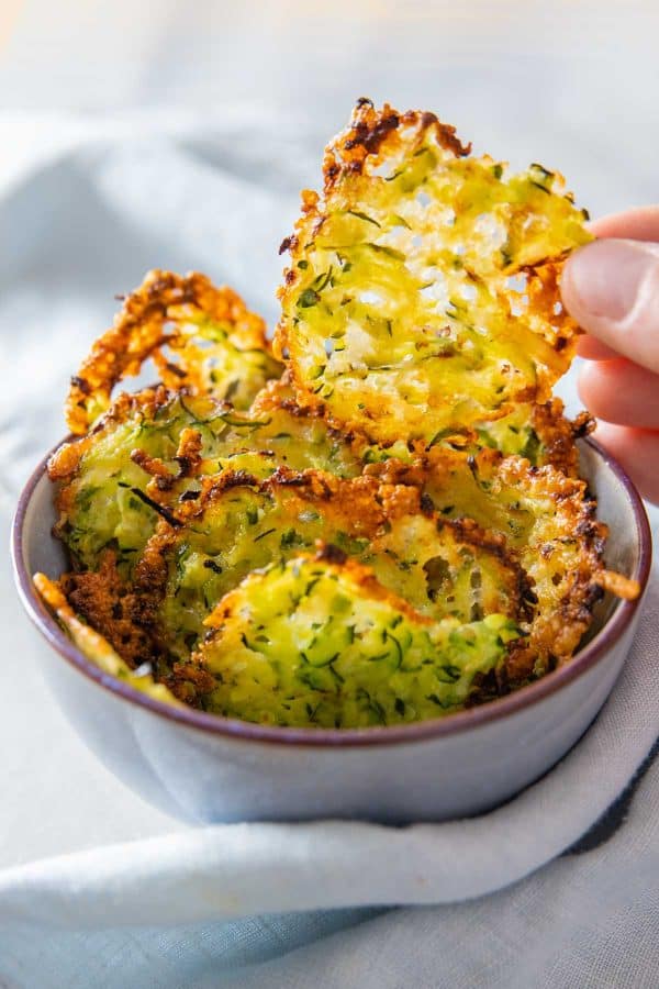 Zucchini Cheese Crisps in a light blue bowl.