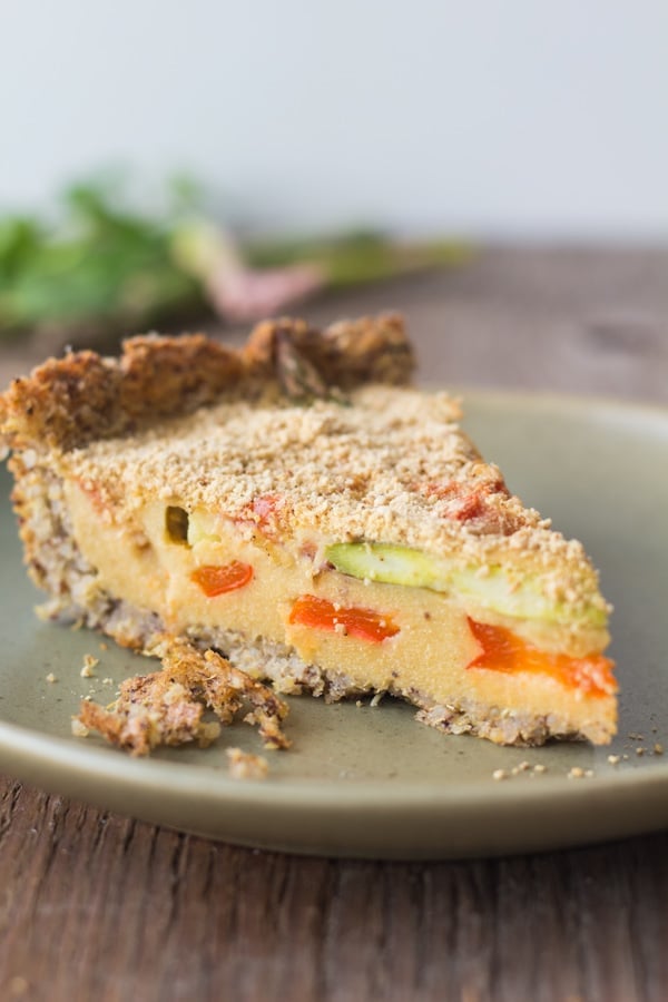 A slice of Flourless Vegan Vegetable Quiche on a plate.