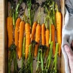 Roasted carrots and broccolini on a baking sheet.