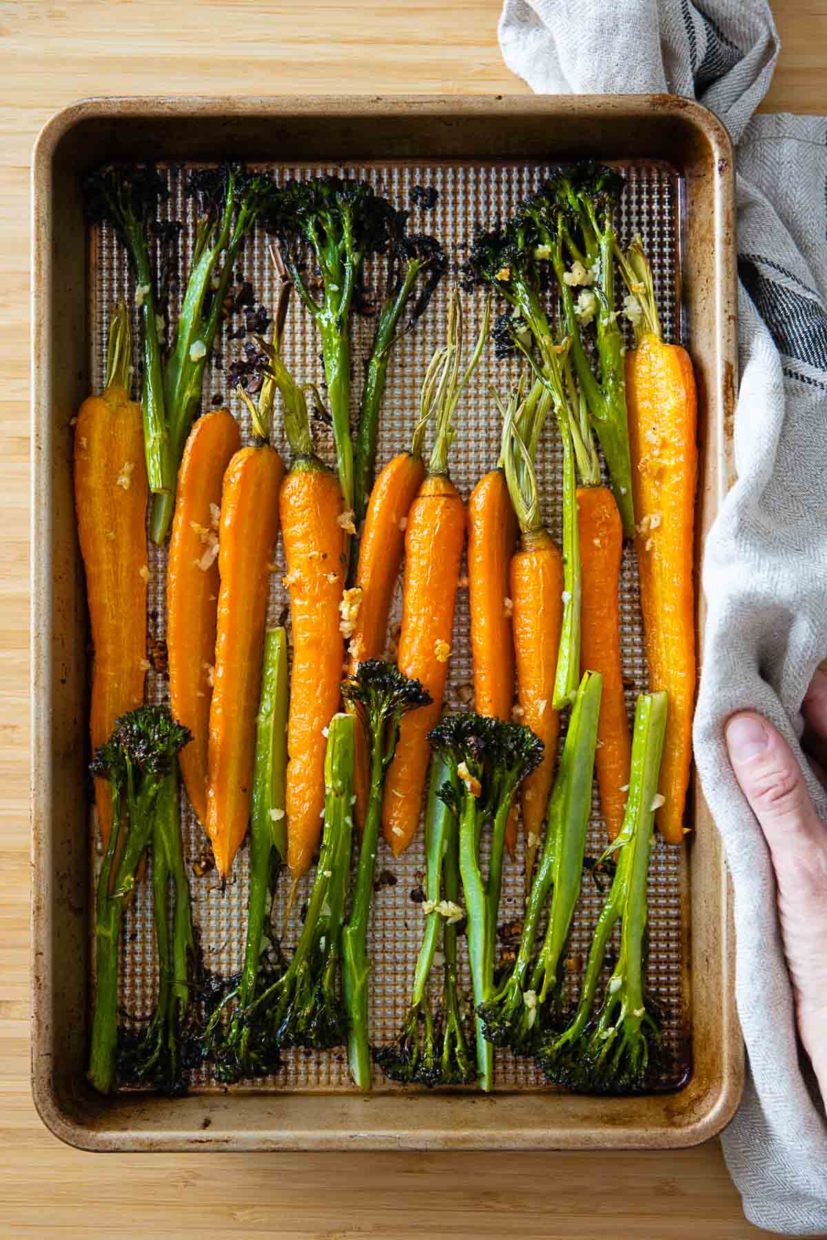 Roasted carrots and broccolini on a baking sheet.