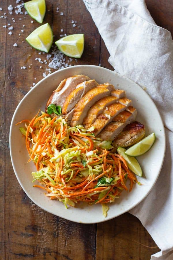 Cabbage Carrot Salad and sliced grilled chicken on a plate