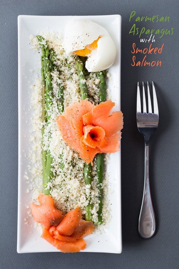 Top view of Parmesan Asparagus with Smoked Salmon on rectangular plate with a fork and text overlay.