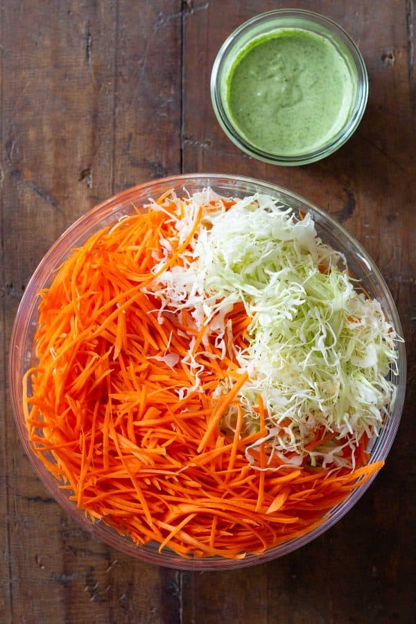 sliced cabbage and grated carrot in a large bowl