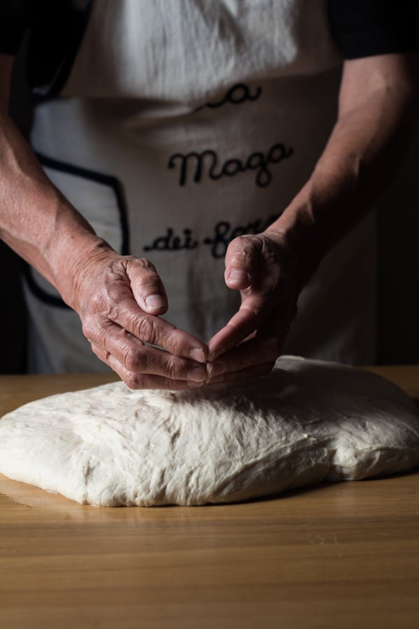 Hands forming loafs of German Bread out of dough