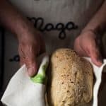 Authentic German Bread held in a kitchen towel in hands