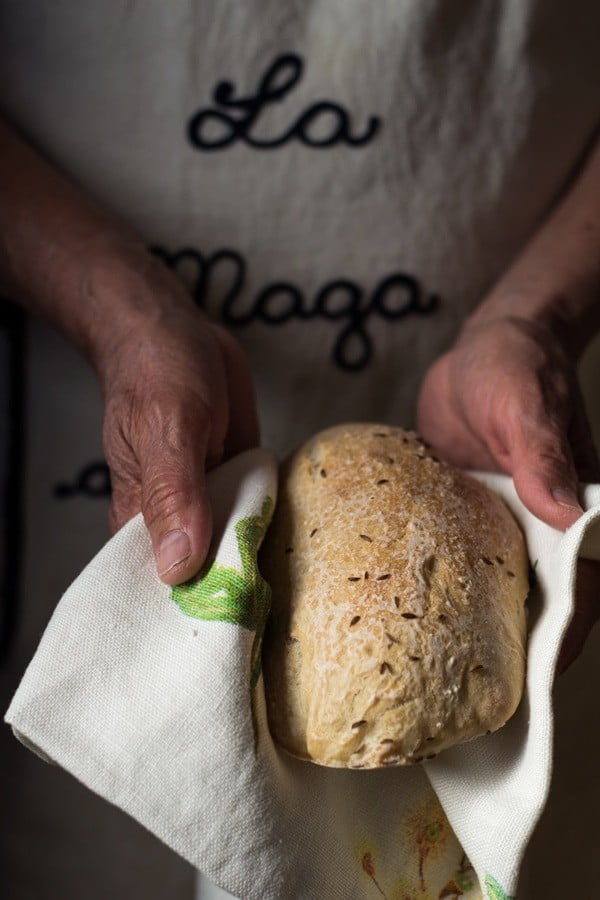 Authentic German Bread held in a kitchen towel in hands