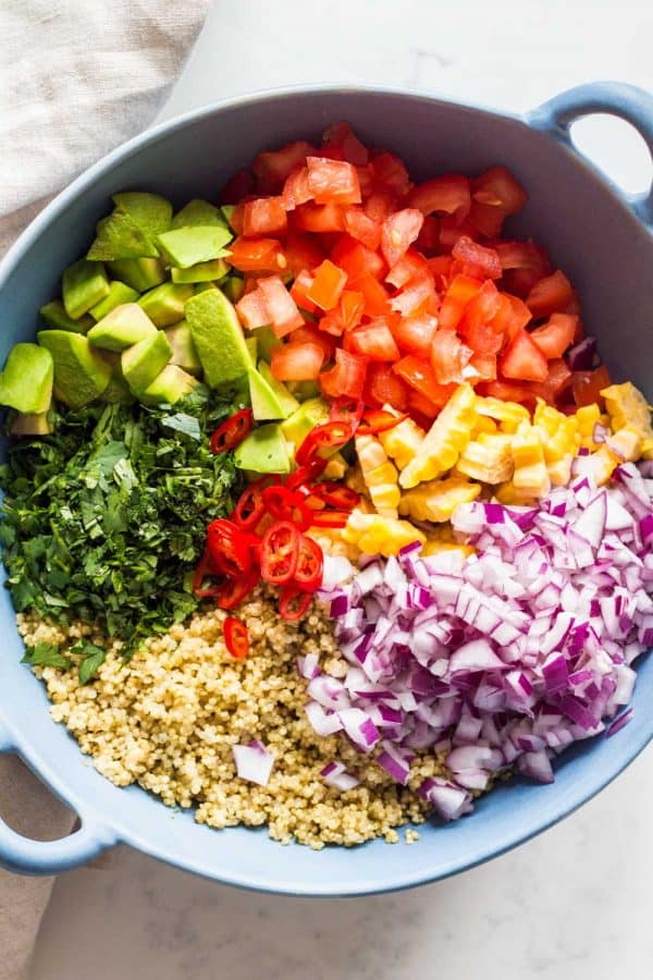 mexicaanse quinoa salade met avocado in grote blauwe slakom