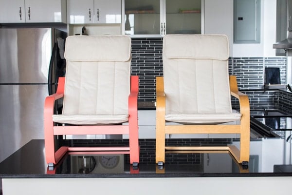 Two small armchairs on a kitchen countertop showing the before and after being painted.