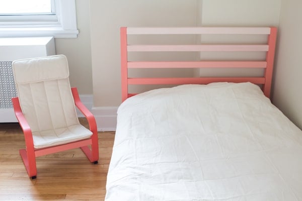 Ikea Tarva Bed and arm chair in a bedroom painted in orange tones.