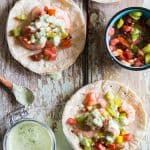 Shrimp Tacos with Cilantro Lime Salsa, a cup of salsa and a cup of chopped tomatoes.