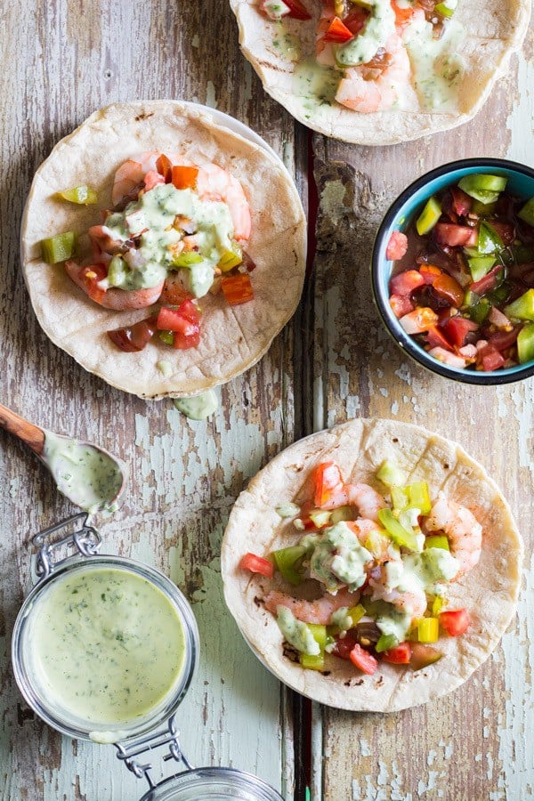 Shrimp Tacos with Cilantro Lime Salsa, a cup of salsa and a cup of chopped tomatoes.