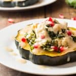 Two plates of Bulgur Stuffed Acorn Squash.