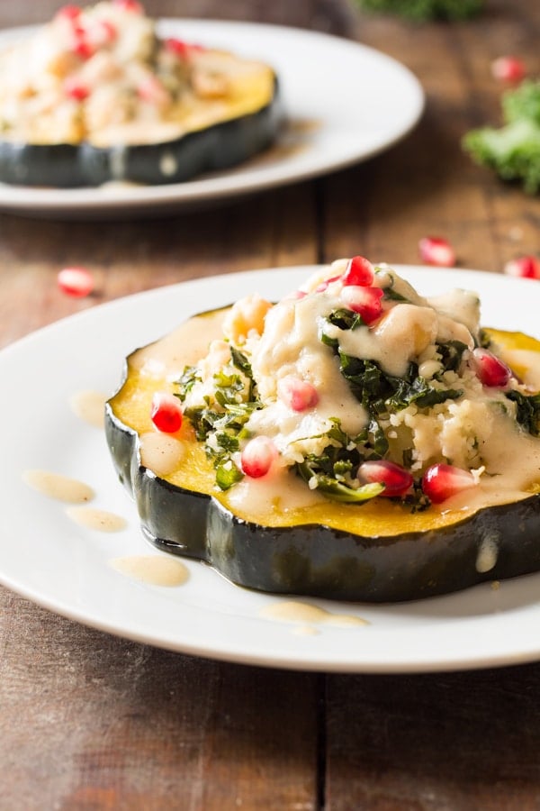 Two plates of Bulgur Stuffed Acorn Squash.