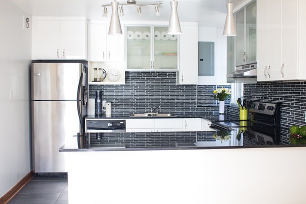 The New Kitchen of Green Healthy Cooking. White cabinets, black backsplash and countertops.