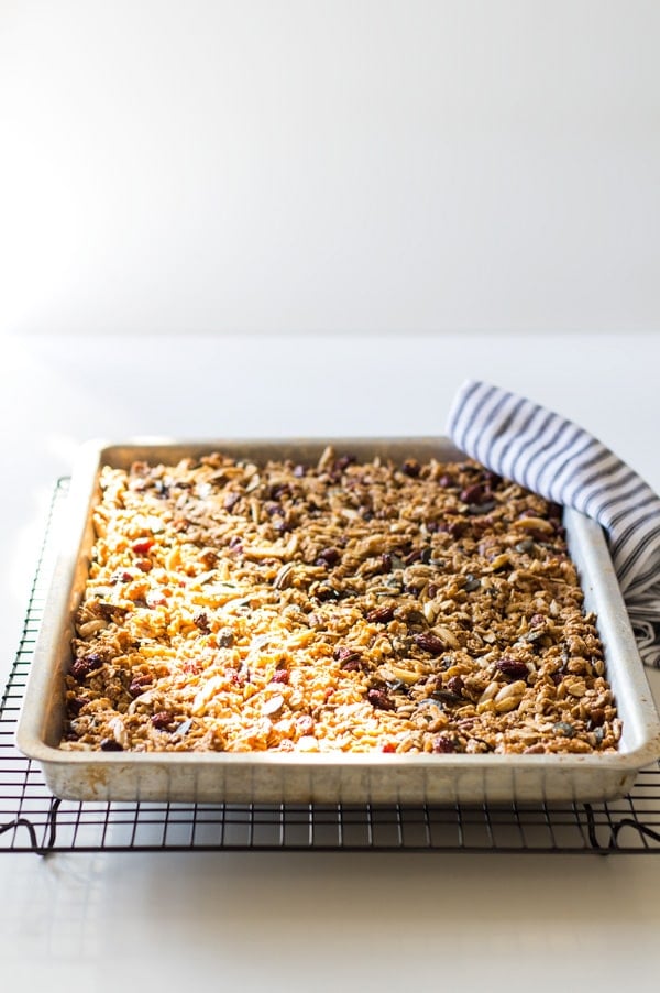 Healthy Homemade Granola in a baking pan cooling on a rack.