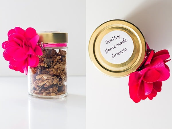 Gift glass jar with Healthy Homemade Granola decorated with a pink flower bow and a written sticker.