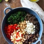 Unmixed wild rice salad ingredients in a blue salad bowl.