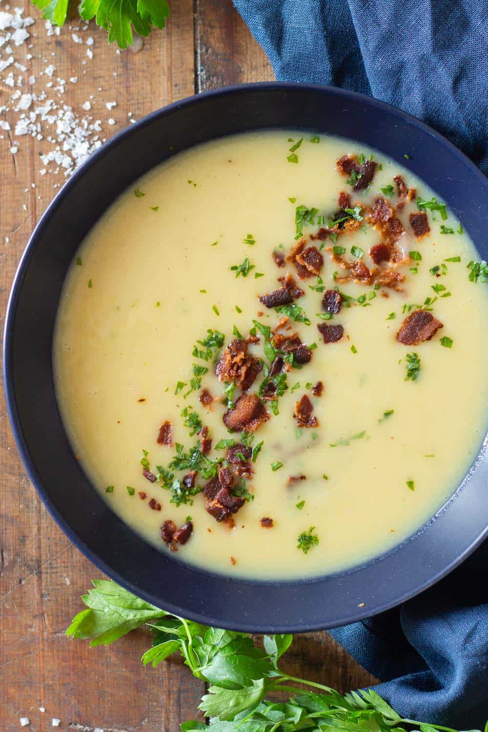 Potato Leek Soup in blue bowl with crispy bacon