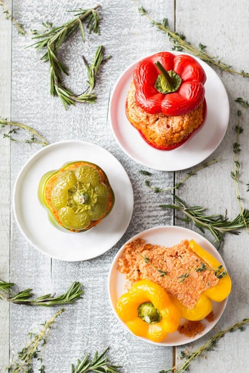 Top view of three Bulgur Stuffed Bell Peppers, red, green and yellow. Yellow is cut open to show filling.