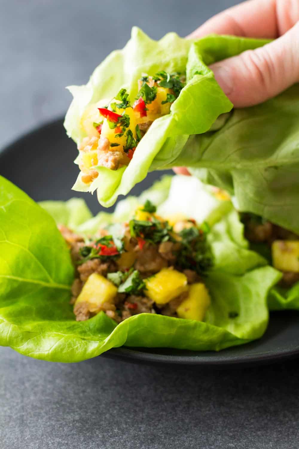 Close up of Ground Pork Lettuce Wrap in hand