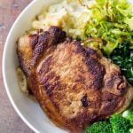 Close up of Perfect Pork Chop with mashed potatoes, celery, chard and broccoli.