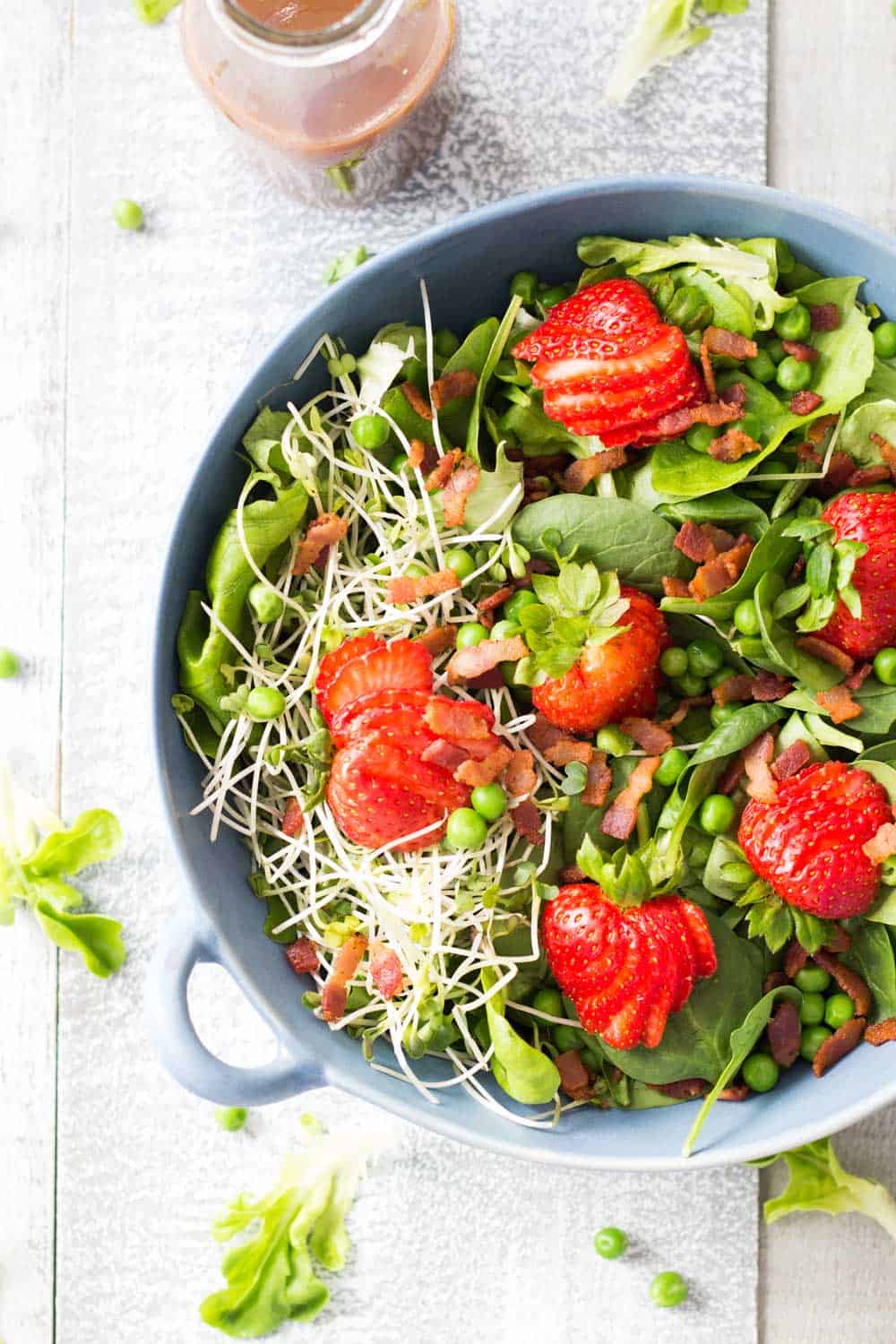 Top view of Strawberry Bacon Spring Salad with Maple Mustard Balsamic Dressing.