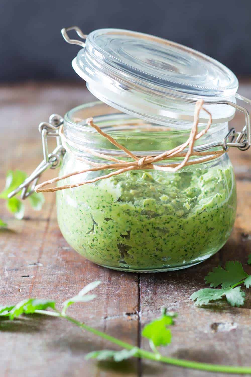 Partially open gift-jar with Cilantro Pesto.