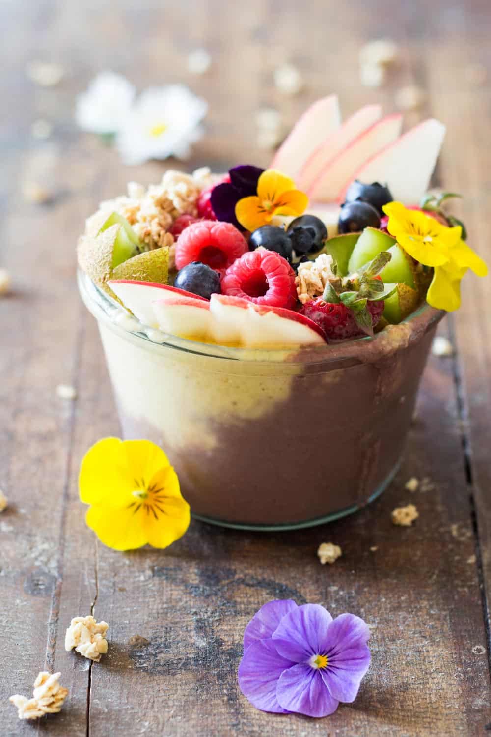 Acai Bowl topped with fresh fruit and flowers.