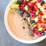 Top view of Chocolate Smoothie Bowl with chopped fresh fruit and seeds.