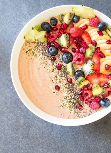 Top view of Chocolate Smoothie Bowl with chopped fresh fruit and seeds.