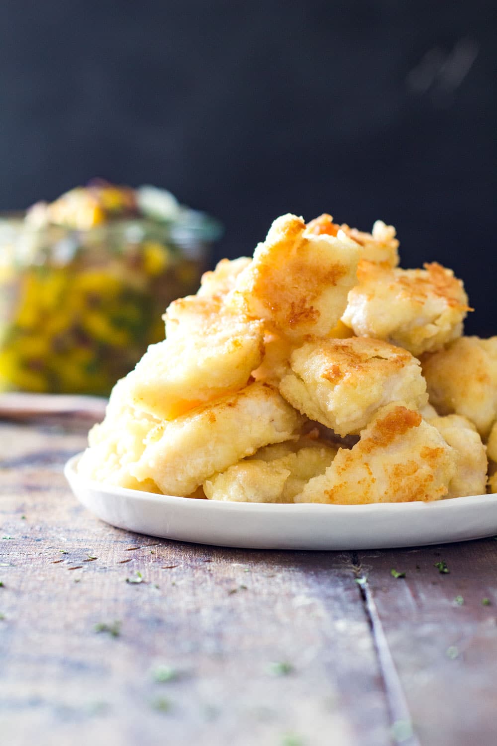 Cooked fish chunks stacked on a plate.