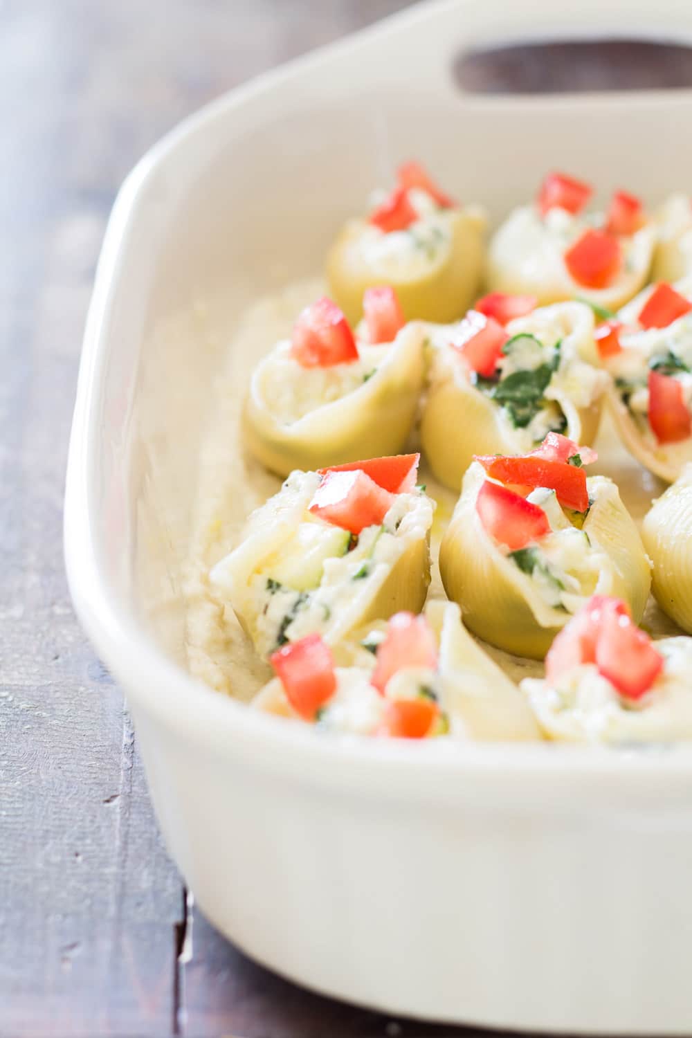 Close up of baking dish with Spinach Ricotta Stuffed Shells to show texture.