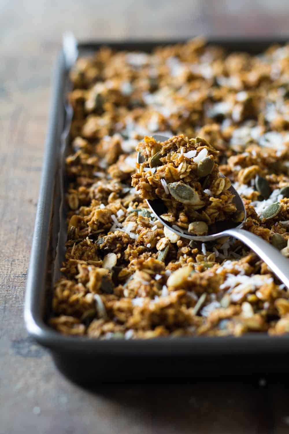 Close up of a spoon with Healthy Pumpkin Granola to show texture.