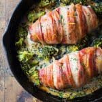 Bacon wrapped chicken breast in a pan with brocooli and creamy suace