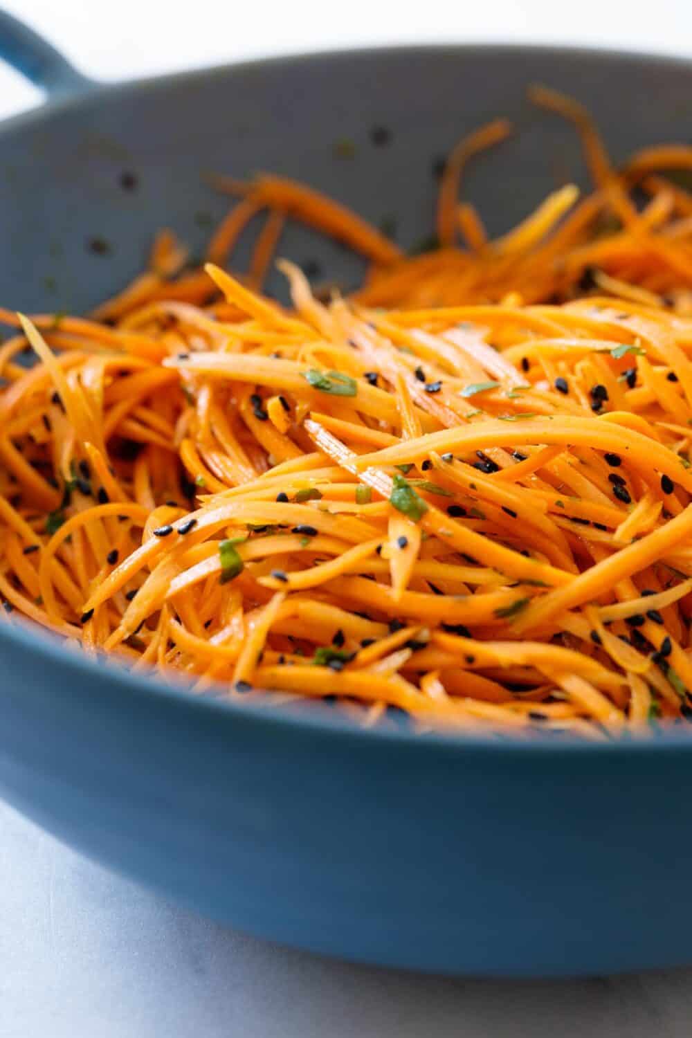 Carrot salad in a blue salad bowl.