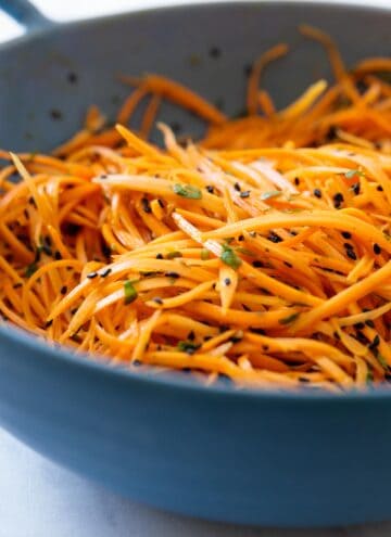 Carrot salad in a blue salad bowl.