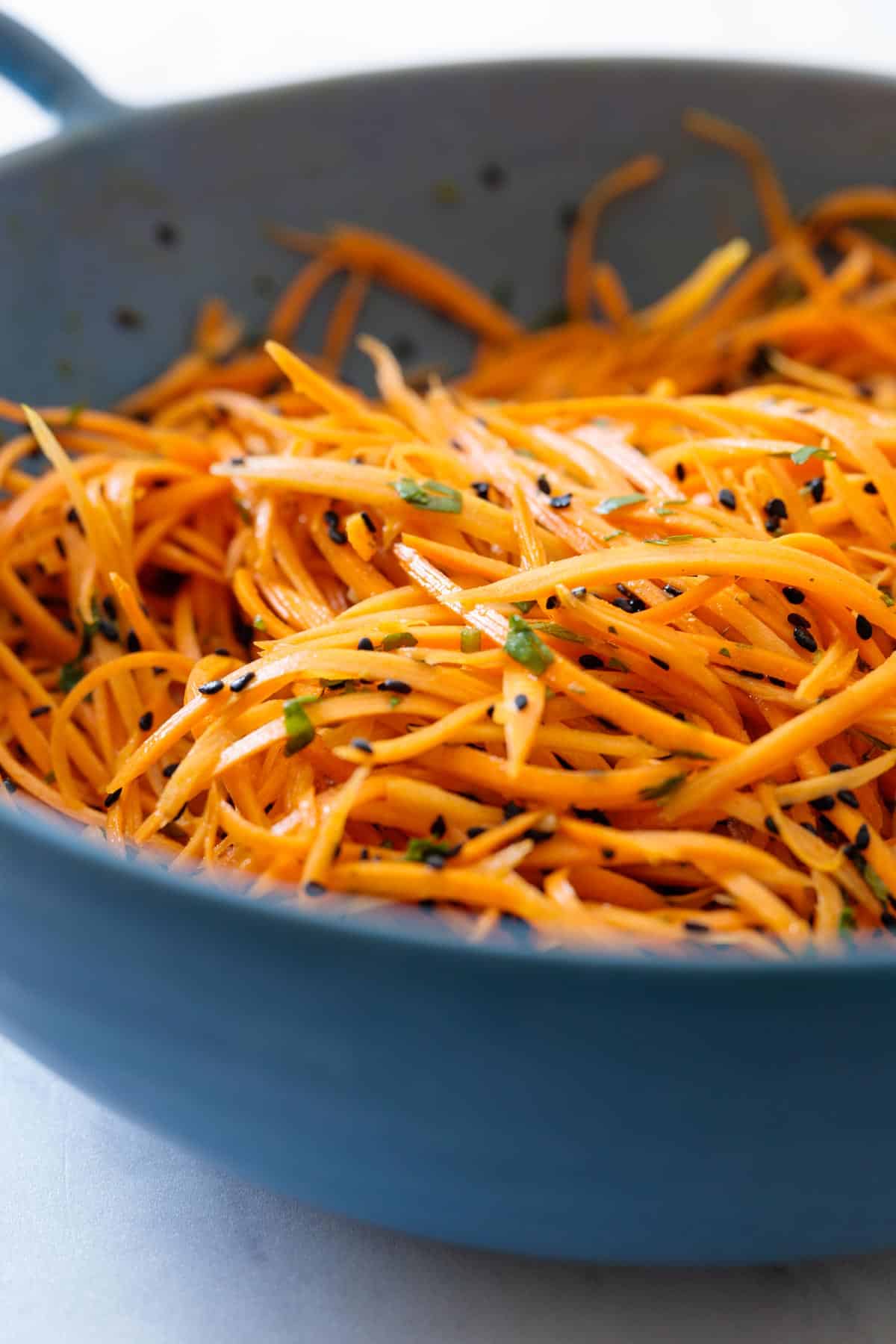 Carrot salad in a blue salad bowl.