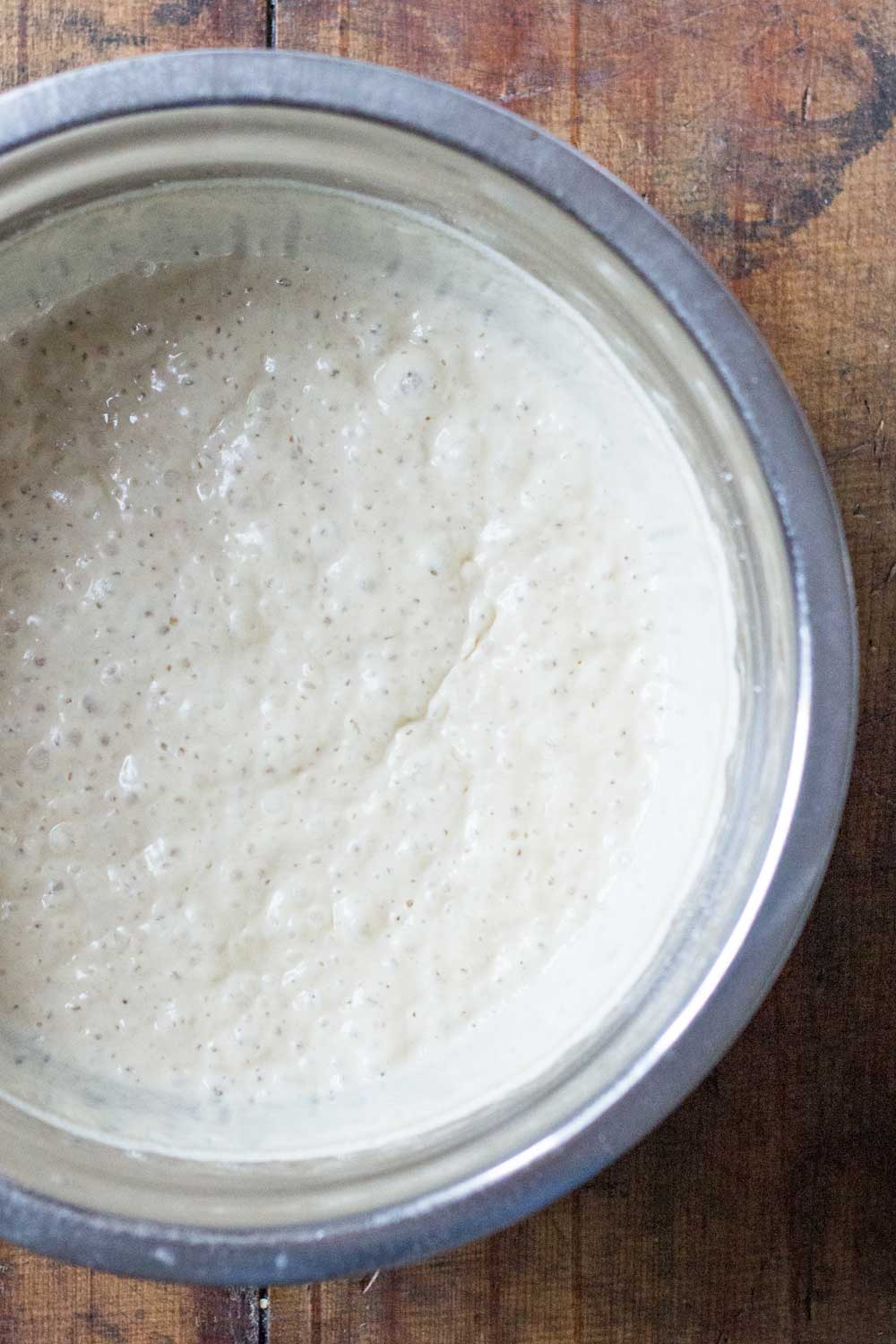 Bubbly apple yeast bread starter in a bowl after 12 hours on kitchen counter at room temperature