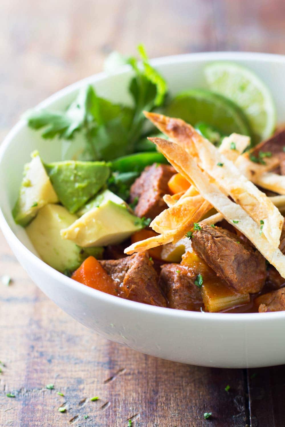 Mexican beef stew with avocado, jalapeño, tortilla chikps and lime. 