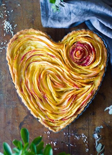 Baked apple tart in heart-shaped tart pan.