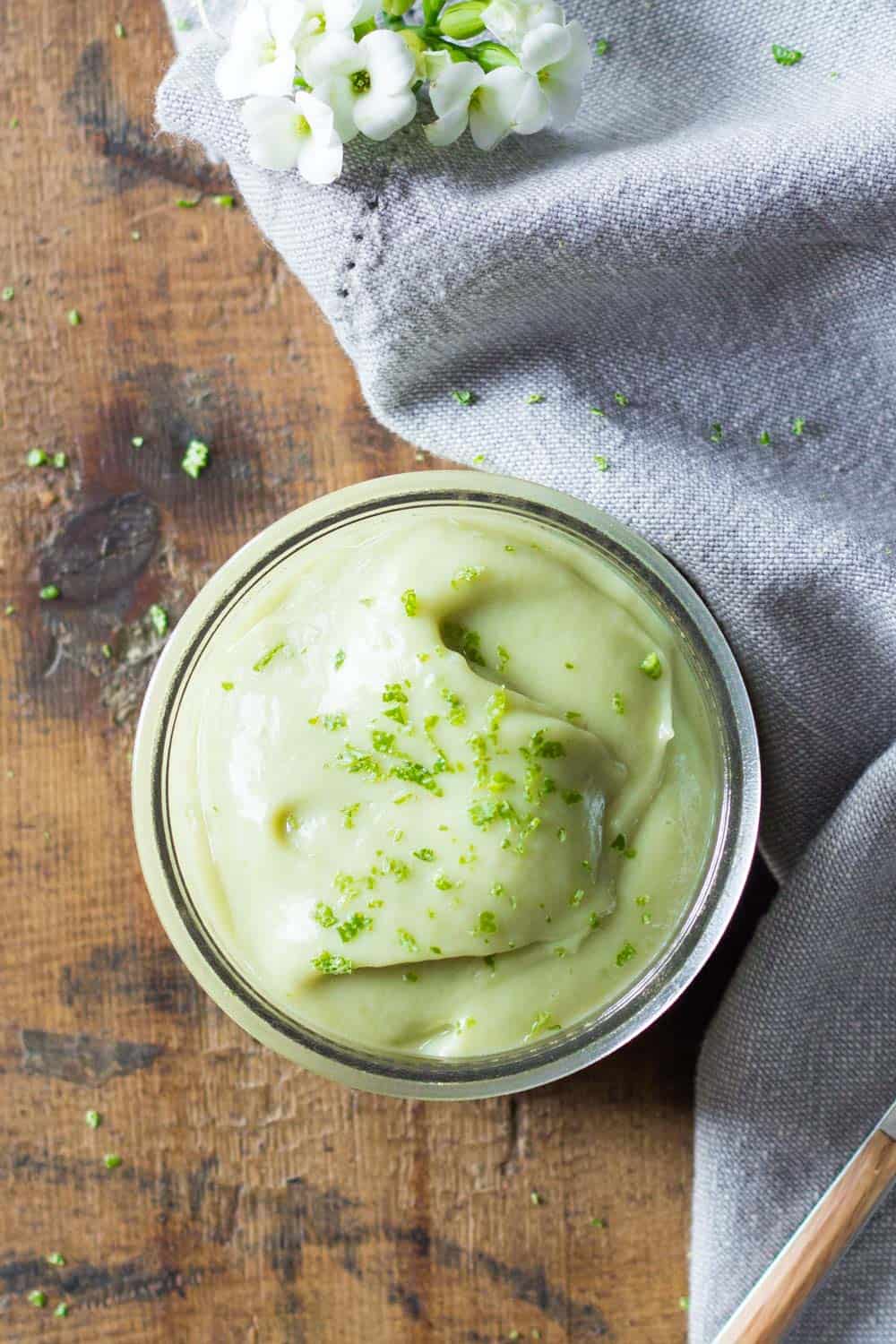 Top view of key lime pudding in a glass jar. 