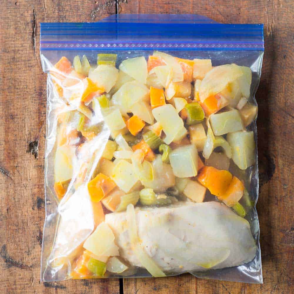 chicken breast with root vegetables as healthy freezer meal in Ziploc bag