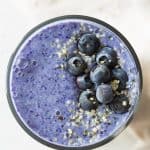 top down view of blue smoothie with blueberries