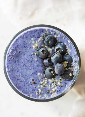 top down view of blue smoothie with blueberries