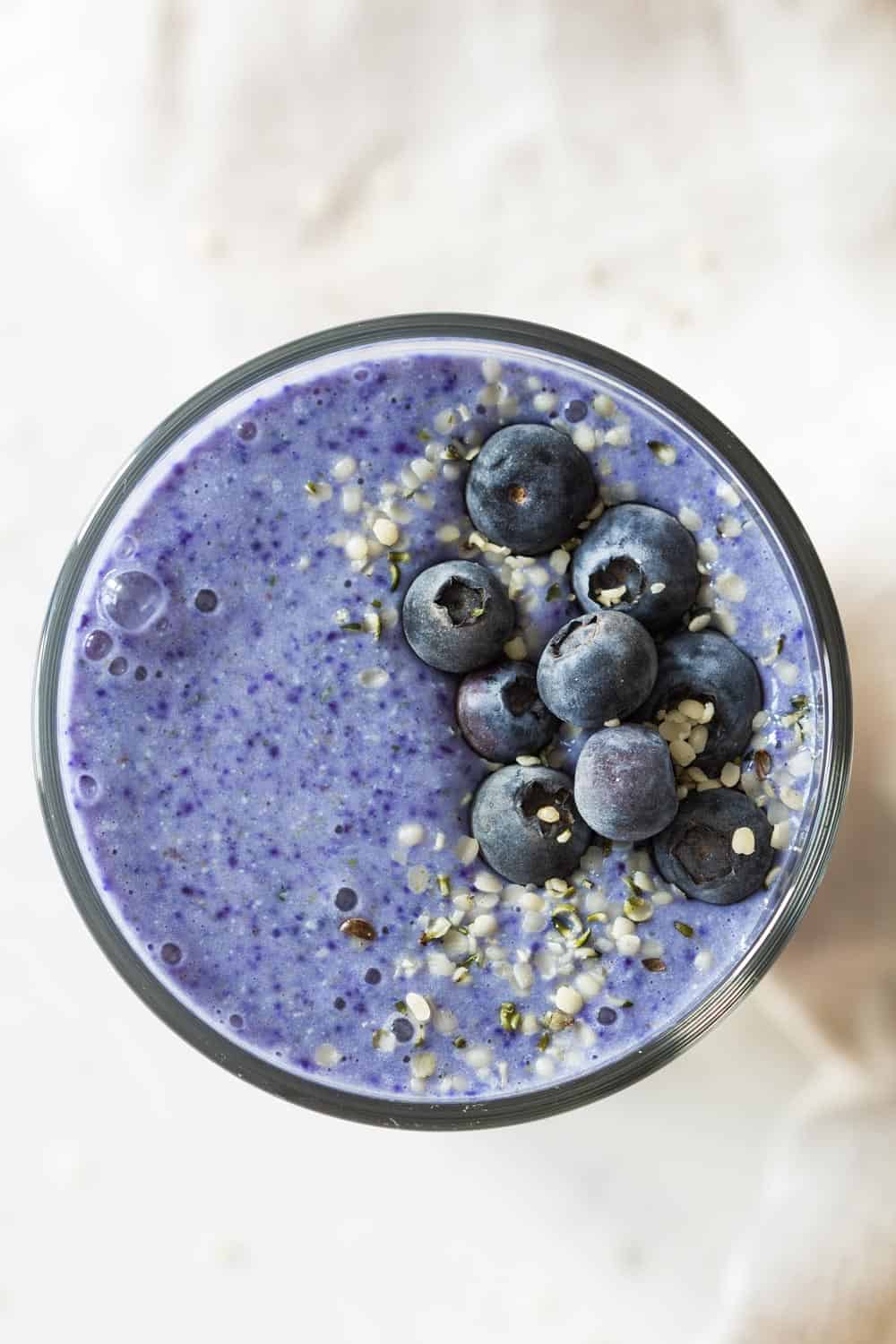 top down view of blue smoothie with blueberries