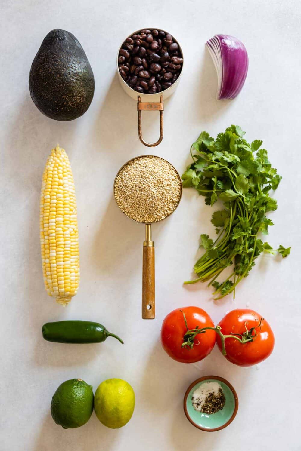 All ingredients for Mexican Quinoa Salad laid out on a kitchen counter.