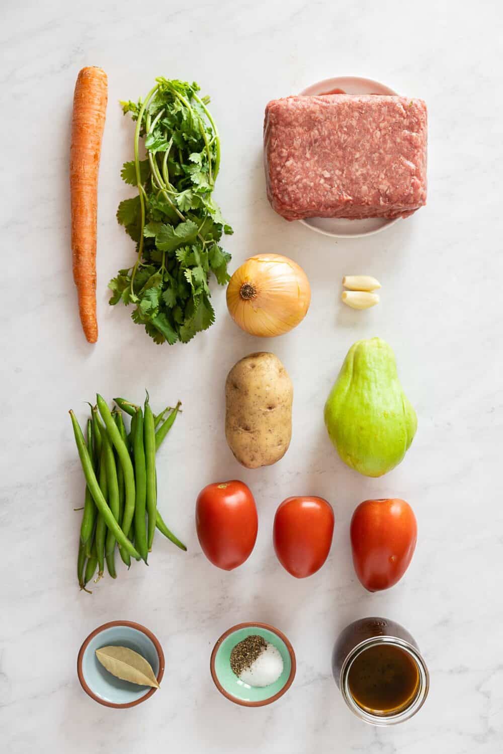 All ingredients required to make Mexican Picadillo on a kitchen counter.